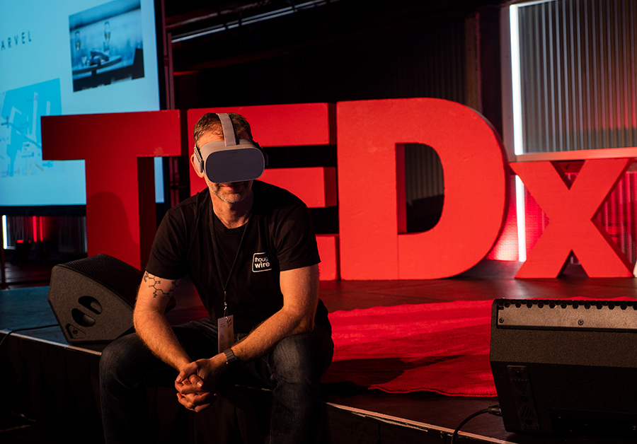 Talking Mimes creator Stefan wearing the Oculus Go sitting on the TEDx stage